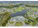 Aerial view showing community clubhouse, pool, and surrounding landscape at 1044 Blyth Hill Ct, Trinity, FL 34655