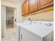 Bright laundry room with washer, dryer, and ample cabinet storage at 1044 Blyth Hill Ct, Trinity, FL 34655