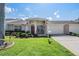 Brick front home with two-car garage and well-manicured lawn at 1044 Blyth Hill Ct, Trinity, FL 34655