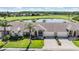 Two-story home with attached garage, front yard, and golf course views at 1044 Blyth Hill Ct, Trinity, FL 34655