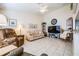 Living room with a comfortable couch, recliner, and large TV at 1044 Blyth Hill Ct, Trinity, FL 34655