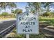 Community entrance sign: Caution Adults at Play at 1044 Blyth Hill Ct, Trinity, FL 34655