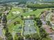 Aerial view of community with tennis courts, golf course, and homes at 1044 Blyth Hill Ct, Trinity, FL 34655