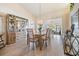 Bright dining room with a wooden table and chairs, hardwood floors at 1044 Blyth Hill Ct, Trinity, FL 34655