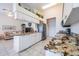 Eat-in kitchen with granite countertops and island seating at 1044 Blyth Hill Ct, Trinity, FL 34655