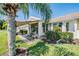 Covered patio with seating area, grill, and lush landscaping at 1044 Blyth Hill Ct, Trinity, FL 34655