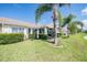 Backyard patio with lush landscaping and partial view of neighboring homes at 1044 Blyth Hill Ct, Trinity, FL 34655