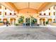 Elegant building entrance with covered walkway and lush landscaping at 5823 Bowen Daniel Dr # 905, Tampa, FL 33616