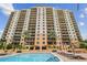 High rise building with pool and surrounding landscape at 5823 Bowen Daniel Dr # 905, Tampa, FL 33616