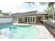 Inviting kidney-shaped pool with a large patio and fenced backyard at 379 Fan Palm Ne Ct # 0, St Petersburg, FL 33703