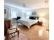 Spacious bedroom with a comfortable bed, hardwood floors, and ample light at 5750 80Th N St # C108, St Petersburg, FL 33709