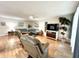 Bright living room featuring hardwood floors, comfy seating, and a large TV at 5750 80Th N St # C108, St Petersburg, FL 33709