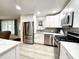 Modern kitchen featuring stainless steel appliances and white cabinets at 5750 80Th N St # C108, St Petersburg, FL 33709