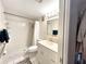 Bathroom with a tub shower combo, toilet, and vanity with storage at 5750 80Th N St # C108, St Petersburg, FL 33709