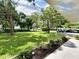 Spacious grassy backyard with mature trees and a park-like setting at 5750 80Th N St # C108, St Petersburg, FL 33709