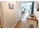 Light and airy entryway with wood floors and a view into the kitchen at 5750 80Th N St # C108, St Petersburg, FL 33709