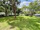Landscaped backyard with lush green grass and large trees at 5750 80Th N St # C108, St Petersburg, FL 33709