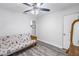 Bedroom with futon, ceiling fan, and wood-look floors at 5609 20Th S Ave, Gulfport, FL 33707