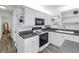 White kitchen with stainless steel appliances and ample storage at 5609 20Th S Ave, Gulfport, FL 33707