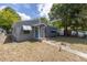 Gray house with a blue door, featuring a walkway and landscaping at 5609 20Th S Ave, Gulfport, FL 33707