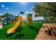 Playground with a large yellow slide and climbing area at 169 Sun Isle Cir # 33, Treasure Island, FL 33706