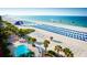 Aerial view of beach with pool, lounge chairs, and water activities at 5500 Gulf Blvd # 7253, St Pete Beach, FL 33706