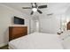 Main bedroom with a king-size bed, ceiling fan, and dresser at 36750 Us Highway 19 N # 13202, Palm Harbor, FL 34684