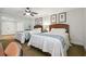 Bright guest bedroom featuring two beds and a ceiling fan at 36750 Us Highway 19 N # 13202, Palm Harbor, FL 34684