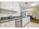 Fully equipped kitchen with granite counters and white cabinets at 36750 Us Highway 19 N # 13202, Palm Harbor, FL 34684