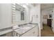 Bathroom with granite countertop, white cabinets, and a large mirror at 36750 Us Highway 19 N # 13202, Palm Harbor, FL 34684