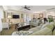 Open living space featuring plush sofas, a coffee table, and a view into the dining area at 36750 Us Highway 19 N # 13202, Palm Harbor, FL 34684