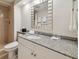 Bathroom features granite countertop, white cabinets, and a large mirror at 36750 Us Highway 19 N # 13202, Palm Harbor, FL 34684