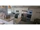 Well-lit kitchen featuring granite countertops, stainless steel refrigerator, modern appliances, and white cabinetry at 2312 22Nd Sw Ave, Largo, FL 33774