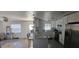 Light and bright kitchen featuring granite countertops, stainless steel refrigerator, modern appliances, and white cabinetry at 2312 22Nd Sw Ave, Largo, FL 33774