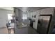 Stylish kitchen featuring granite countertops, stainless steel appliances, white cabinets, and an eat-in bar with seating at 2312 22Nd Sw Ave, Largo, FL 33774