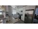Modern kitchen with granite countertops, stainless steel appliances, white cabinets, and a breakfast bar area with seating at 2312 22Nd Sw Ave, Largo, FL 33774