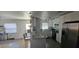 Bright kitchen with an eat-in bar, stainless steel appliances, white cabinets, and a window overlooking the yard at 2312 22Nd Sw Ave, Largo, FL 33774