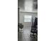 Living area with tile floors, fan, window with blinds, and black refrigerator at 2312 22Nd Sw Ave, Largo, FL 33774