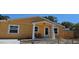 Yellow house with front porch and fenced yard at 2312 22Nd Sw Ave, Largo, FL 33774