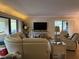 Living area featuring a sectional sofa and flat-screen TV at 36750 Us Highway 19 N # 21-302, Palm Harbor, FL 34684