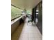 Spacious balcony with tiled floor and seating at 36750 Us Highway 19 N # 21-302, Palm Harbor, FL 34684