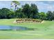 Picturesque golf course with pond and landscaping at 36750 Us Highway 19 N # 21-302, Palm Harbor, FL 34684