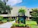 Rosemount Lodge 11 building exterior with landscaping and signage at 36750 Us Highway 19 N # 21-302, Palm Harbor, FL 34684
