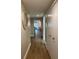 Long hallway with wood floors and neutral walls at 36750 Us Highway 19 N # 21-302, Palm Harbor, FL 34684
