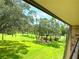 Scenic balcony view of lush greenery, trees, and a tranquil golf course at 36750 Us Highway 19 N # 21-302, Palm Harbor, FL 34684