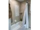 Bathroom with shower/tub combo and neutral tile at 36750 Us Highway 19 N # 21-302, Palm Harbor, FL 34684