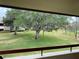 View from balcony of grassy lawn and large oak trees at 36750 Us Highway 19 N # 21-302, Palm Harbor, FL 34684
