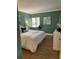 Spacious bedroom with a large bed and teal walls at 36750 Us Highway 19 N # 21-302, Palm Harbor, FL 34684