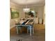 Dining room with farmhouse table and elegant light fixture at 36750 Us Highway 19 N # 21-302, Palm Harbor, FL 34684