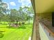 Balcony overlooking a scenic golf course and tranquil landscape at 36750 Us Highway 19 N # 21-302, Palm Harbor, FL 34684